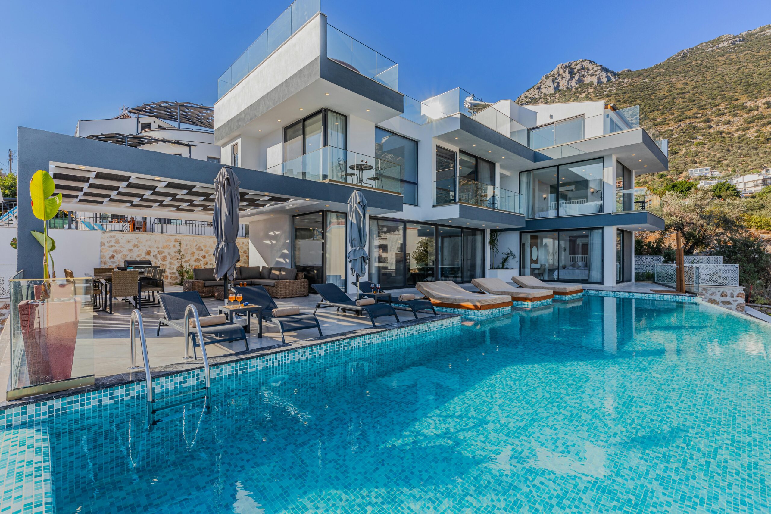 Stunning contemporary villa featuring a spacious infinity pool and breathtaking mountain backdrop.